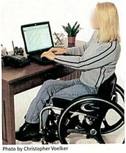 Figure 5: This keyboard is too far away from the user, causing her to reach forward awkwardly. Crossing the legs twists the torso and restricts circulation. 